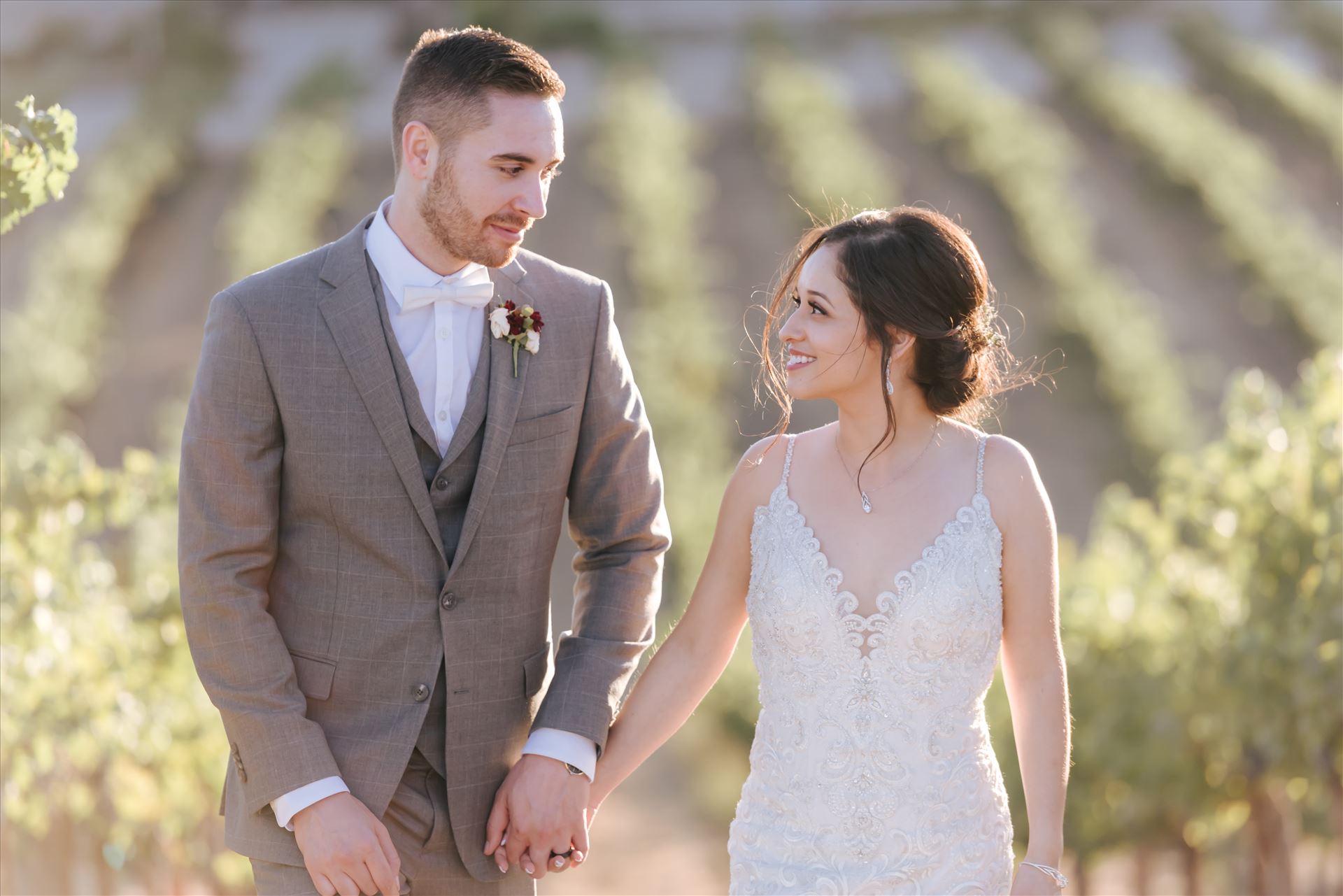 FW-6933.JPGTooth and Nail Winery elegant and formal wedding in Paso Robles California wine country by Mirror's Edge Photography, San Luis Obispo County Wedding Photographer. Bride and Groom walking through the vineyards in Paso Robles California wine country wedding