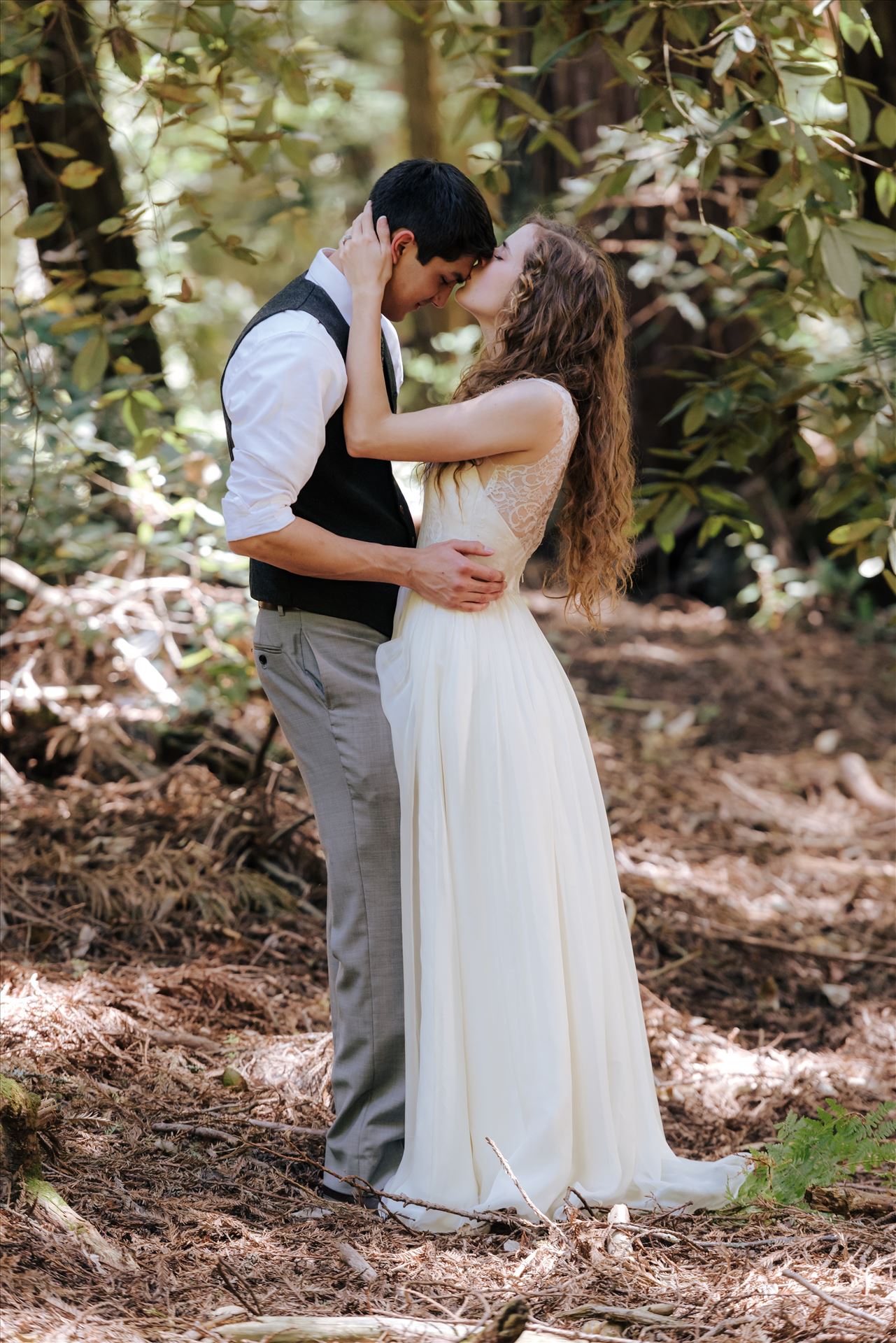 FW-6044.JPG - Mt Madonna wedding in the redwoods outside of Watsonville, California with a romantic and classic vibe by sarah williams of mirror's edge photography a san luis obispo wedding photographer.  Bride kisses groom in the trees by Sarah Williams