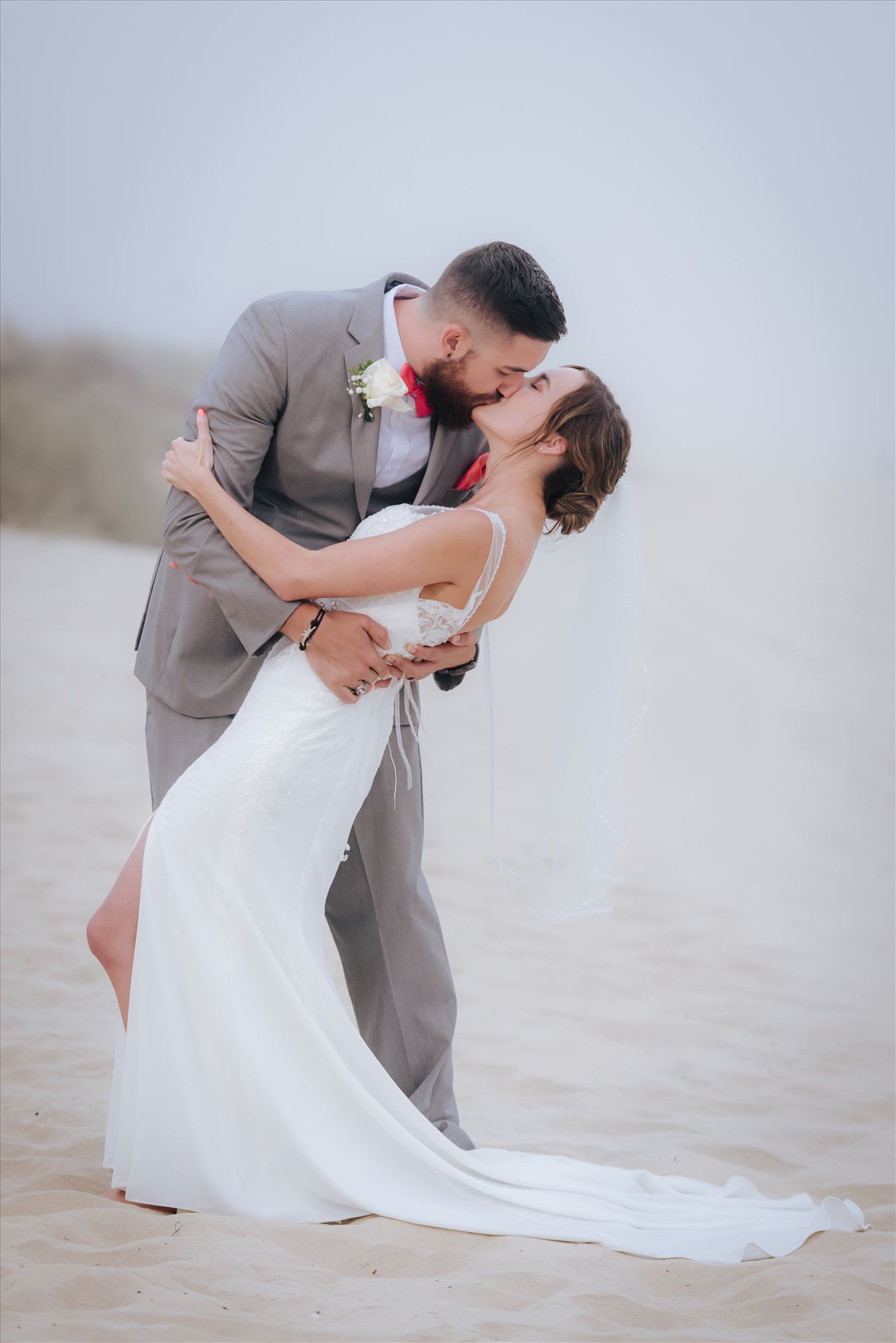 FW-8130.jpg - Romantic wedding in the sand on Grover Beach in California.  Barefoot with surfboards and driftwood, tent and ceremony set up by Beach Butlerz, wedding photography by Mirror's Edge Photography.  Romantic Bride and Groom dip in the fog by Sarah Williams