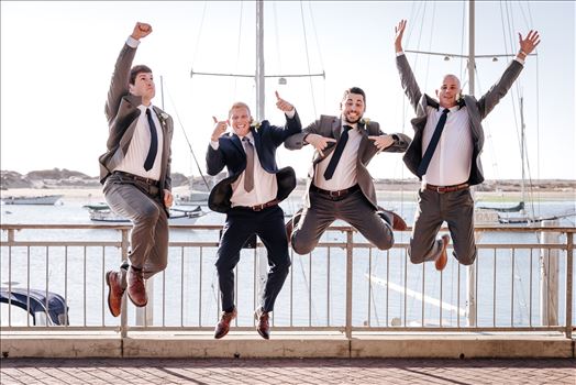 Sarah Williams of Mirror's Edge Photography, a San Luis Obispo Wedding and Engagement Photographer, captures Ryan and Joanna's wedding at the iconic Windows on the Water Restaurant in Morro Bay, California.  Groomsmen jump in front of Morro Rock.