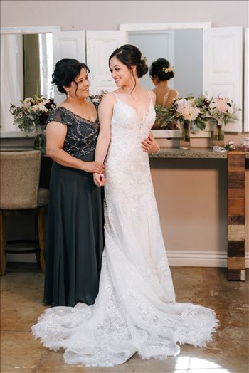 Mirror's Edge Photography captures Edith and Kyle's wedding at the Tooth and Nail Winery in Paso Robles California. Bride getting in to her dress