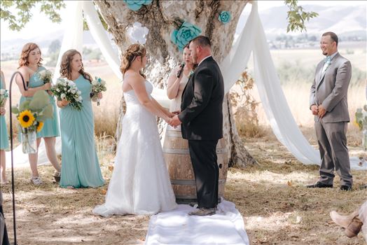 Mirror's Edge Photography, a San Luis Obispo Wedding Photographer, captures a wedding at the Historic Dana Adobe in Nipomo California.  Ceremony under the tree bride and groom.