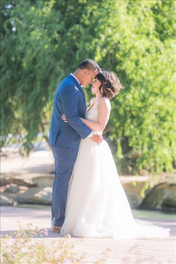 Mirror's Edge Photography captures Maryanne and Michael's magical wedding in the Secret Garden at the iconic Madonna Inn in San Luis Obispo, California. Happy couple by the pond
