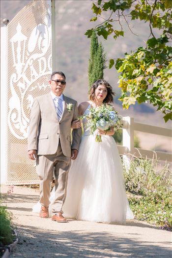 Mirror's Edge Photography captures Maryanne and Michael's magical wedding in the Secret Garden at the iconic Madonna Inn in San Luis Obispo, California. Bride and father enter the Secret Garden