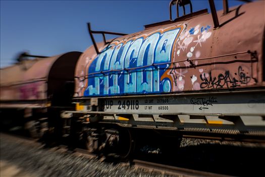 Colorful urban artwork on oil tankers on train tracks