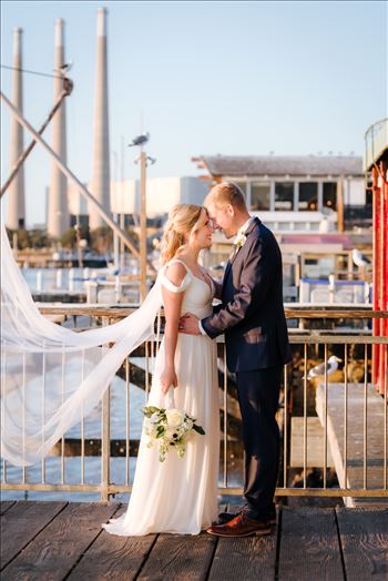 Sarah Williams of Mirror's Edge Photography, a San Luis Obispo Wedding and Engagement Photographer, captures Ryan and Joanna's wedding at the iconic Windows on the Water Restaurant in Morro Bay, California.  Bride and Groom with bay in background.
