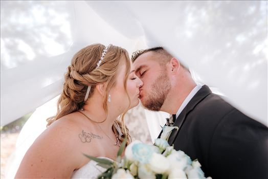 Mirror's Edge Photography, a San Luis Obispo Wedding Photographer, captures a wedding at the Historic Dana Adobe in Nipomo California.  Romantic bride and groom under the veil kiss