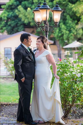 Wedding photography at the Historic Santa Maria Inn in Santa Maria, California by Mirror's Edge Photography. Bride and Groom at the lamppost near back lawn.