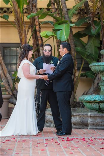 Wedding photography at the Historic Santa Maria Inn in Santa Maria, California by Mirror's Edge Photography. Bride and Groom exchange rings in courtyard