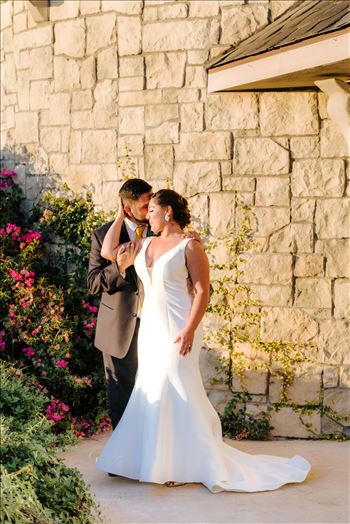 Sarah Williams of Mirror's Edge Photography captures the gorgeous fairy tale wedding day of Victoria and Esteban at the Castle Noland Wedding Venue in San Luis Obispo, California.  Bride and Groom at sunset in front of the castle