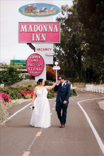 Mirror's Edge Wedding Photography, a San Luis Obispo and Santa Barbara County photographer capture the Nagy's Madonna Inn Wedding. Cool Bride and Groom by Madonna Inn Sign.