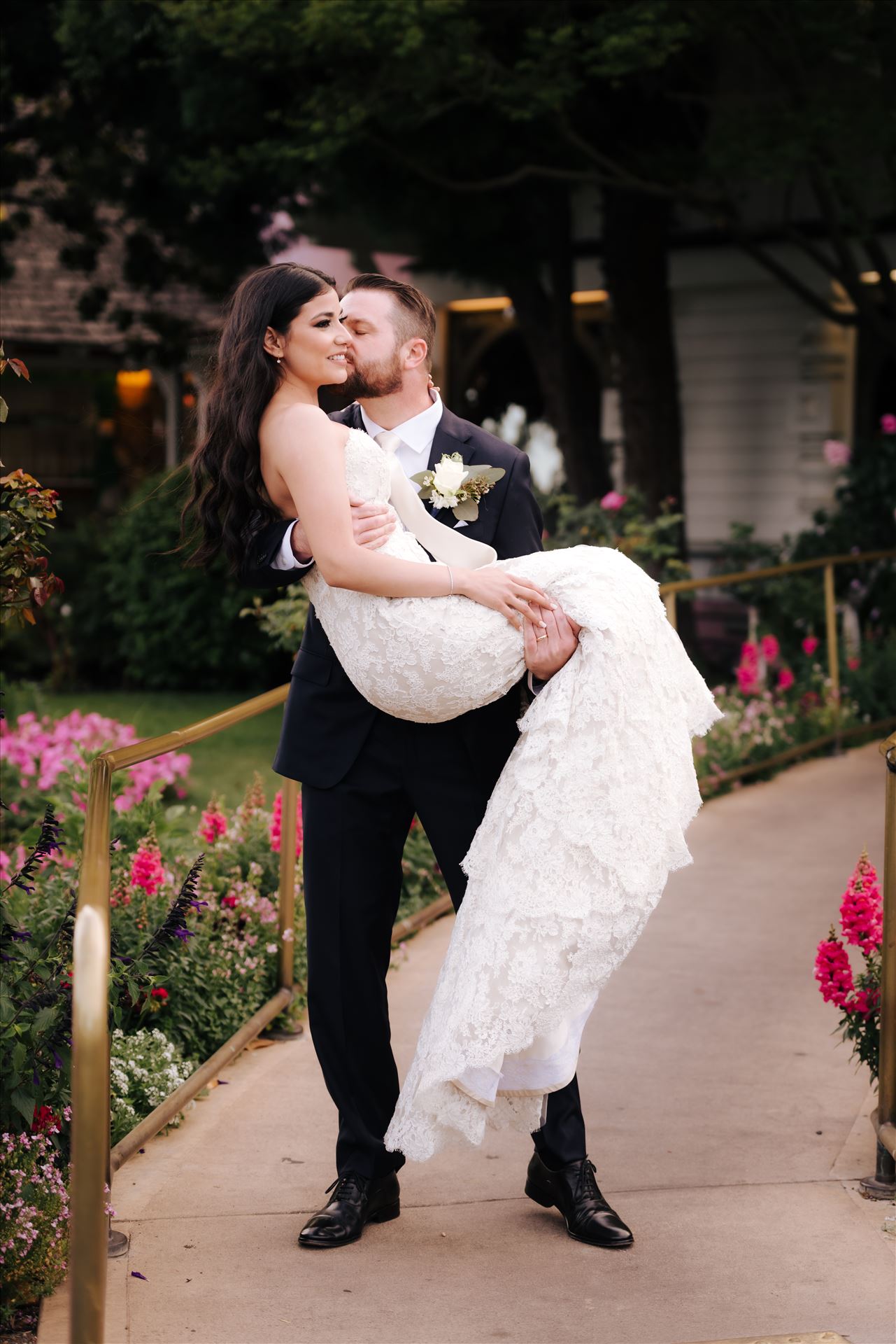 SP Gallery-5906.JPG - Mirror's Edge Photography captures Xochitl and David's magical Madonna Inn Wedding in San Luis Obispo, California. Groom carries Bride in front of Madonna Inn Restaurant. by Sarah Williams