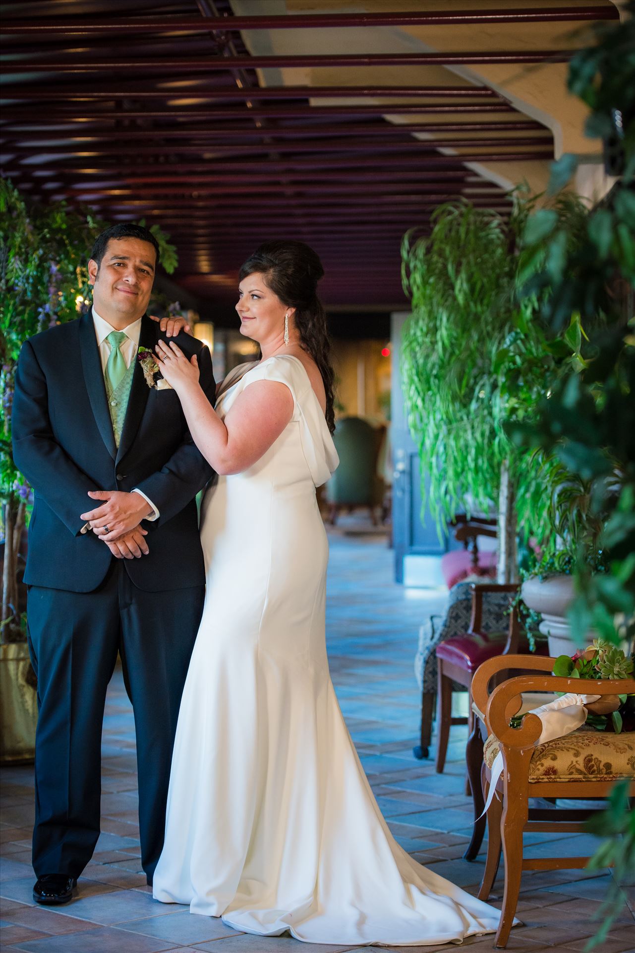 Mary and Alejandro 15 - Wedding photography at the Historic Santa Maria Inn in Santa Maria, California by Mirror's Edge Photography. Bride and Groom in breezeway between the Taproom and the Front Desk at the Santa Maria Inn. by Sarah Williams