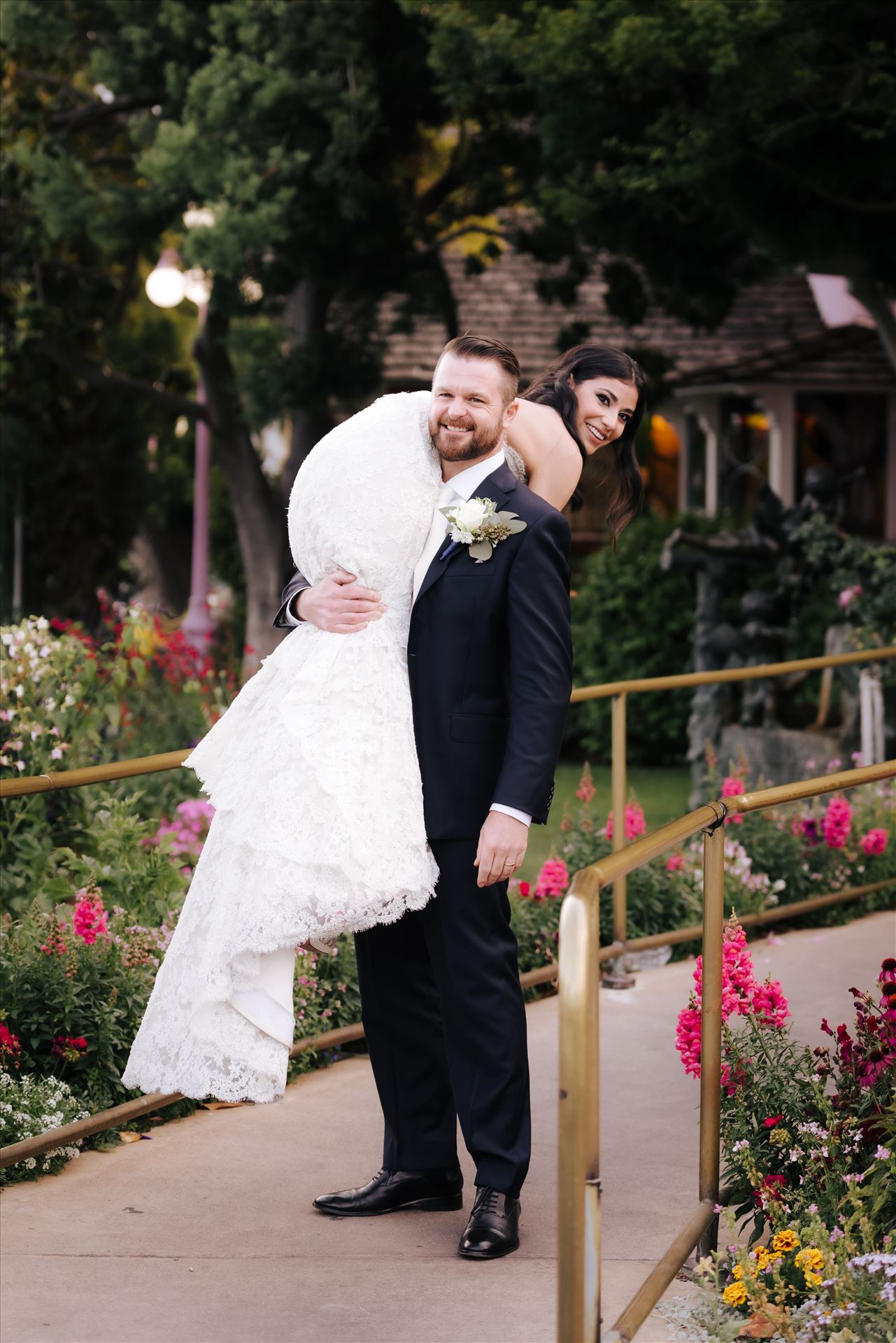 SP Gallery-5878.JPG - Mirror's Edge Photography captures Xochitl and David's magical Madonna Inn Wedding in San Luis Obispo, California. Groom carries away his Bride in front of the Madonna Inn Restaurant. by Sarah Williams