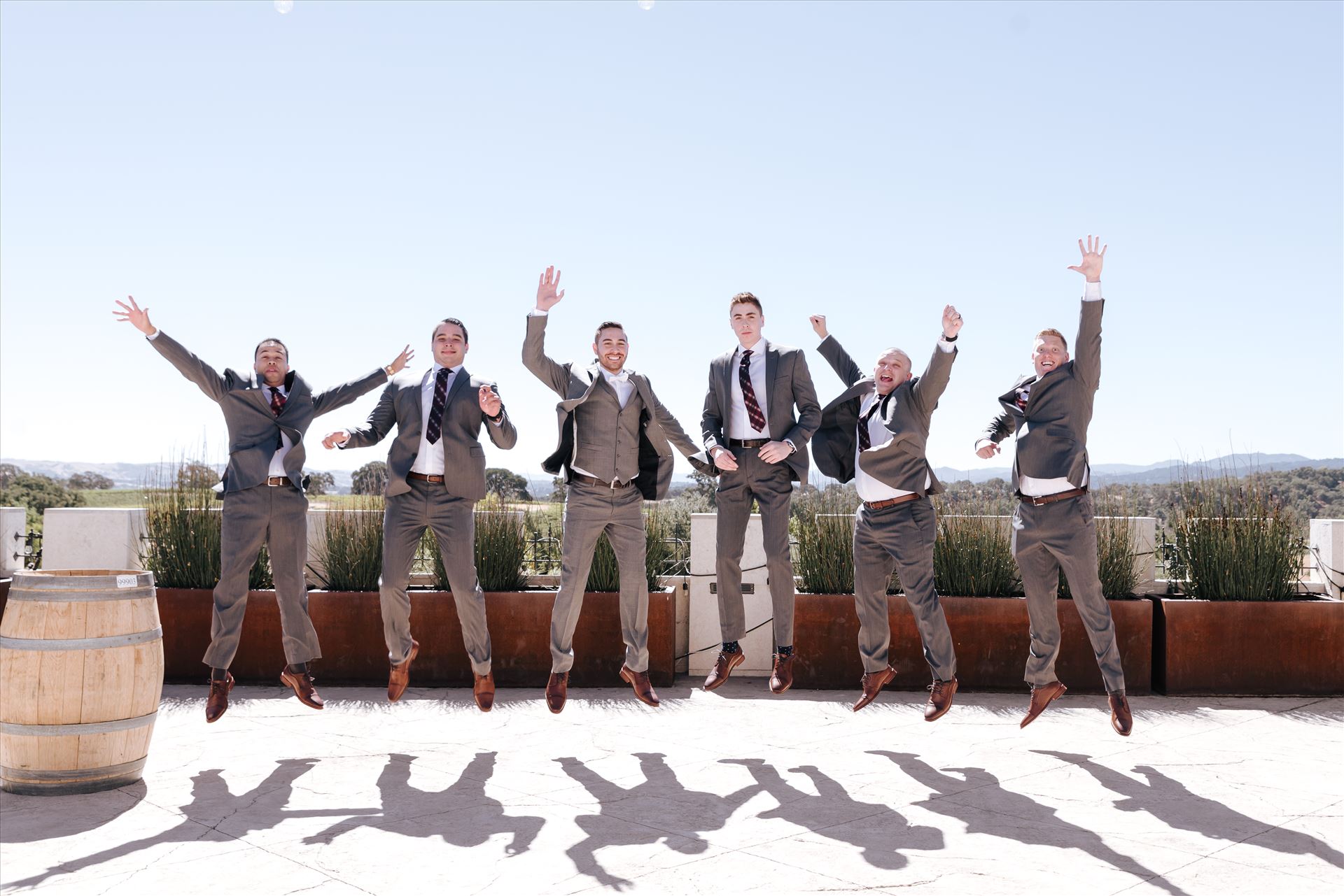 Edith and Kyle 004 - Mirror's Edge Photography captures Edith and Kyle's wedding at the Tooth and Nail Winery in Paso Robles California. Groom and Groomsmen do the jump. by Sarah Williams