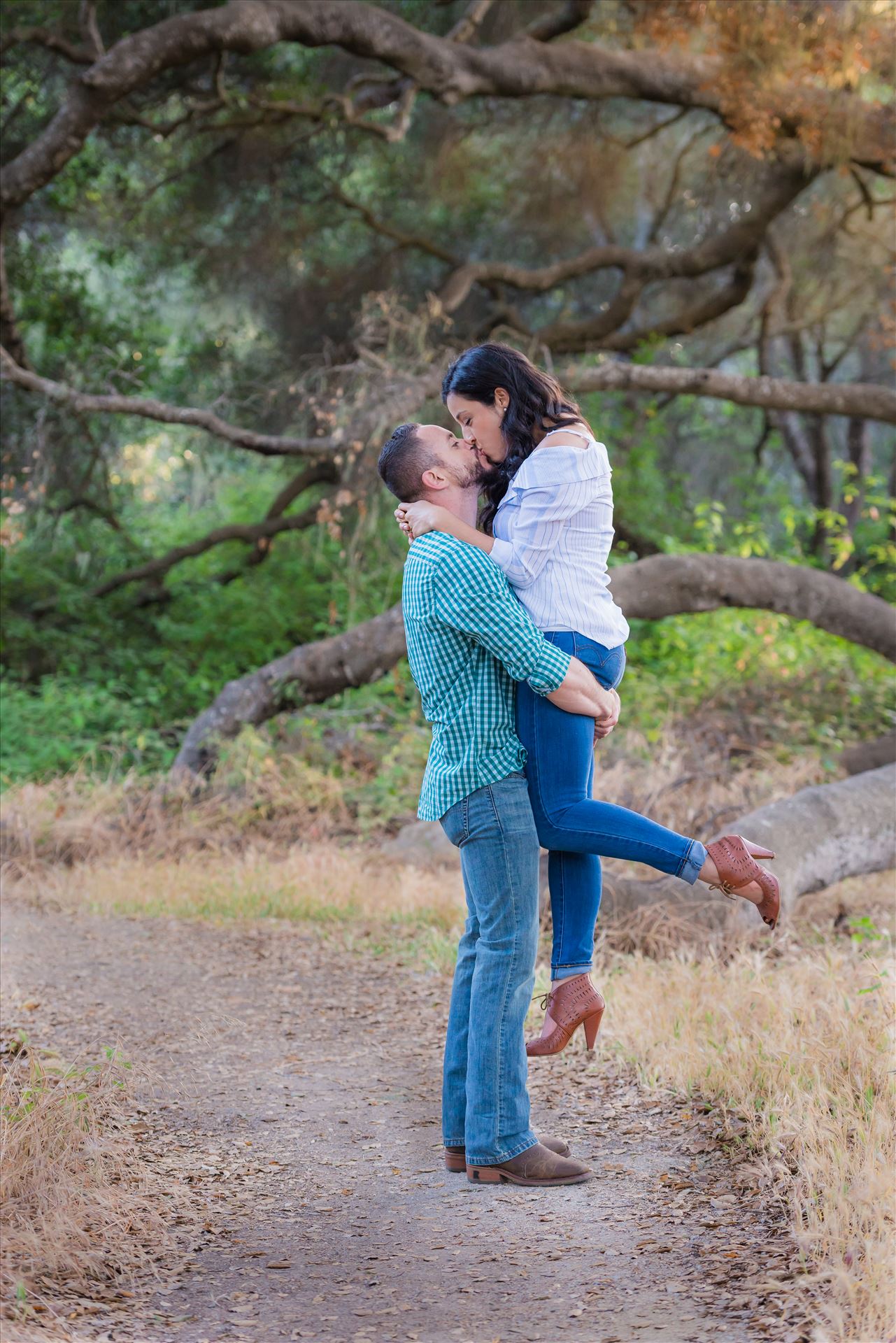 Cinthya and Carlos 61 - Los Osos State Park Reserve Engagement Photography and Wedding Photography by Mirror's Edge Photography.  Holding her up with a kiss by Sarah Williams