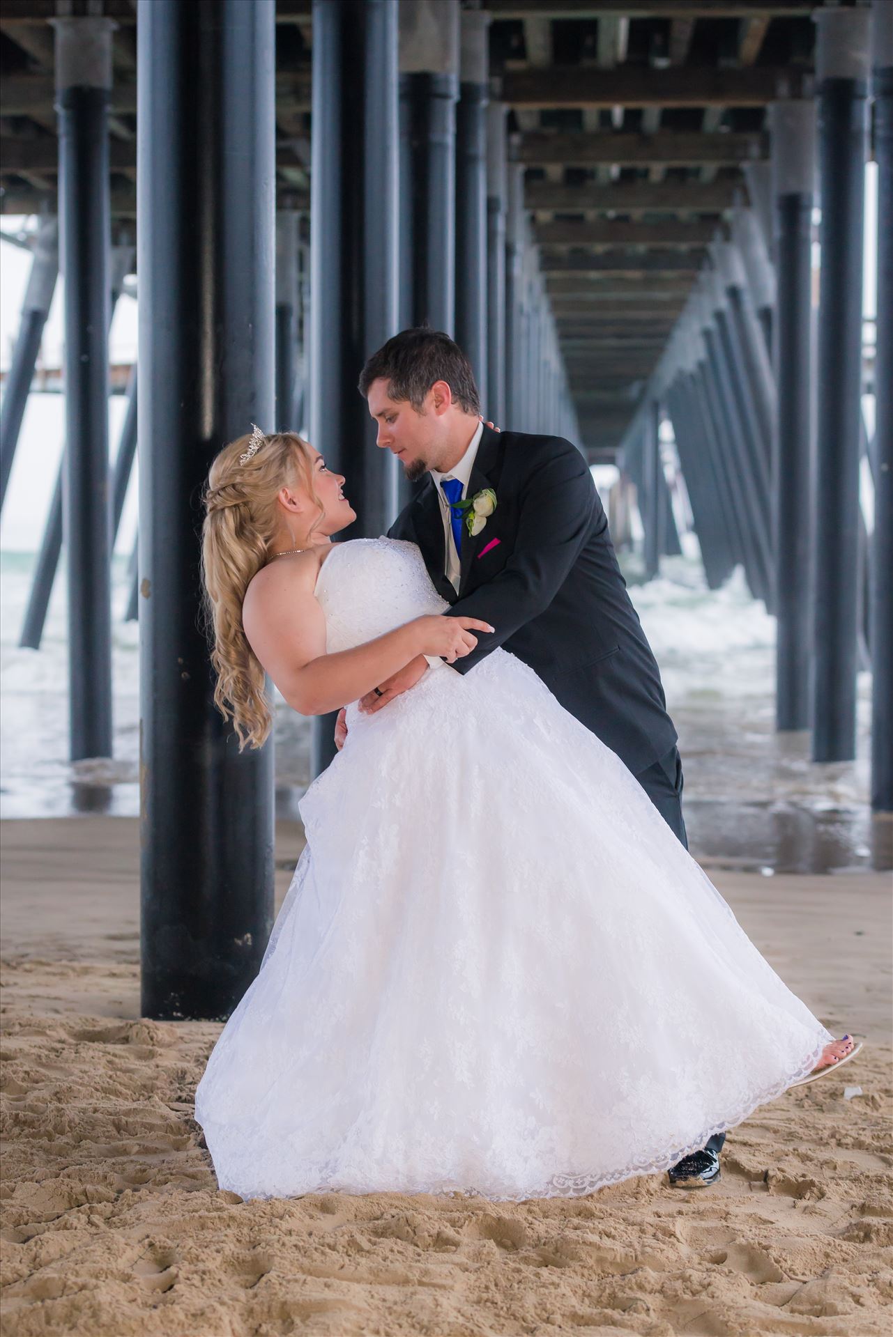 Jessica and Michael 69 - Sea Venture Resort and Spa Wedding Photography by Mirror's Edge Photography in Pismo Beach, California. Bride and Groom under Pismo Beach Pier by Sarah Williams