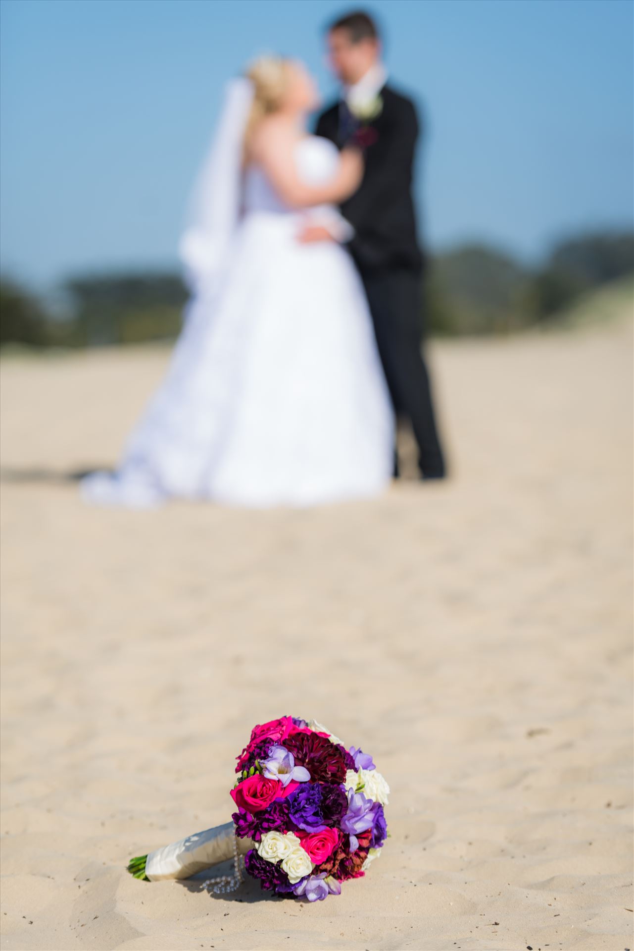 Jessica and Michael 03 - Sea Venture Resort and Spa Wedding Photography by Mirror's Edge Photography in Pismo Beach, California. Flowers on the Beach with Bride and Groom by Sarah Williams