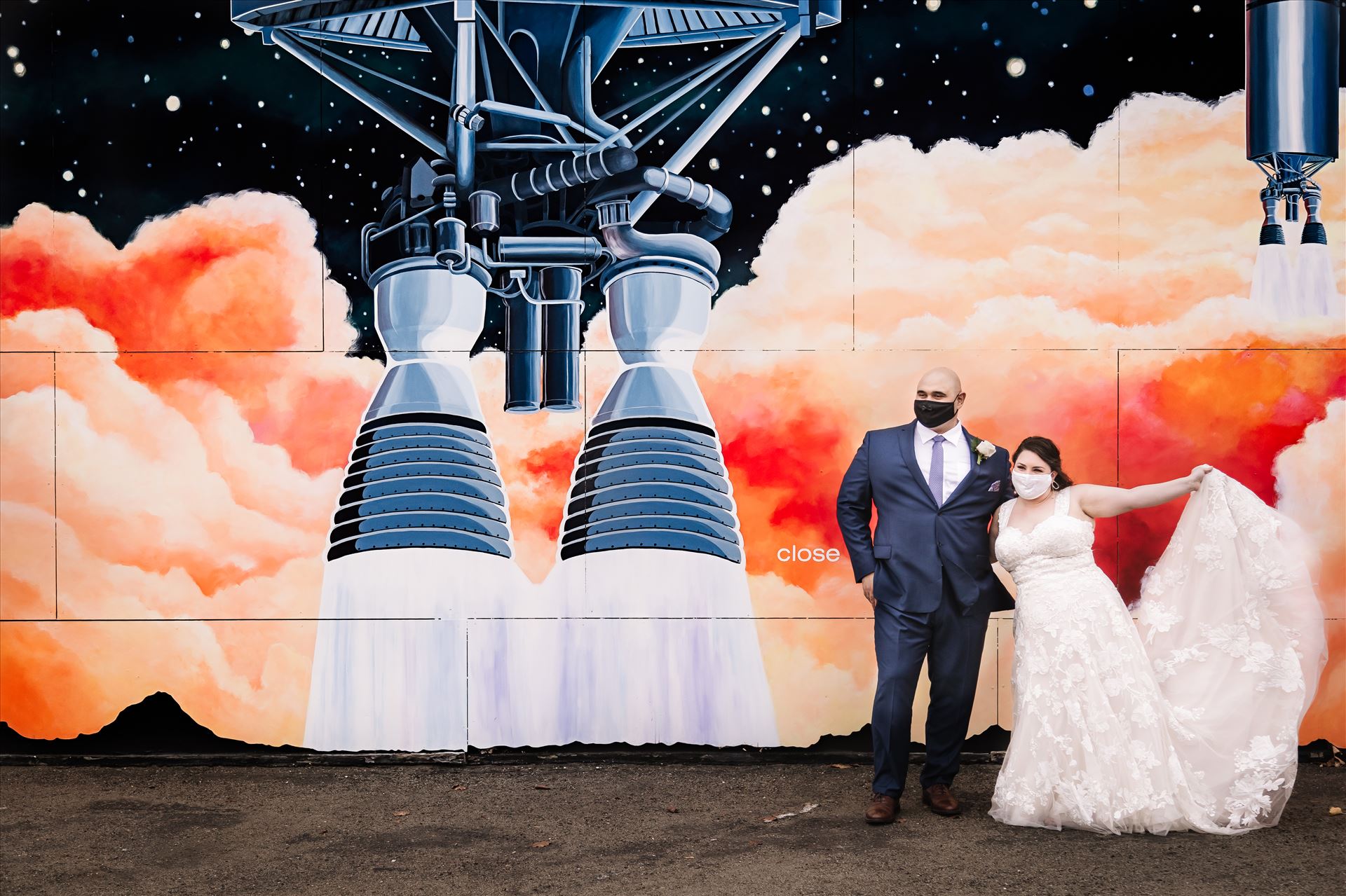 FW-3467.JPG - Sarah Williams of Mirror's Edge Photography and San Luis Obispo and Santa Barbara Wedding Photographer captures the Ochoa Wedding. Bride and Groom with Covid 19 Masks at Rocket Mural in Lompoc California. by Sarah Williams