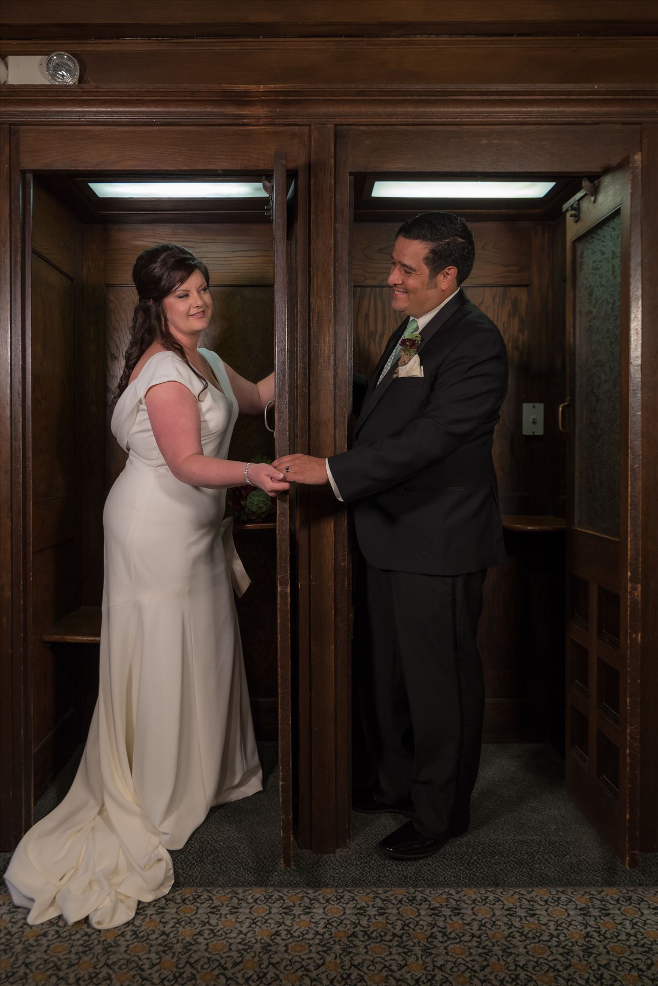 Mary and Alejandro 30 - Wedding photography at the Historic Santa Maria Inn in Santa Maria, California by Mirror's Edge Photography. Bride and Groom in vintage phone booths inside of the Santa Maria Inn. by Sarah Williams