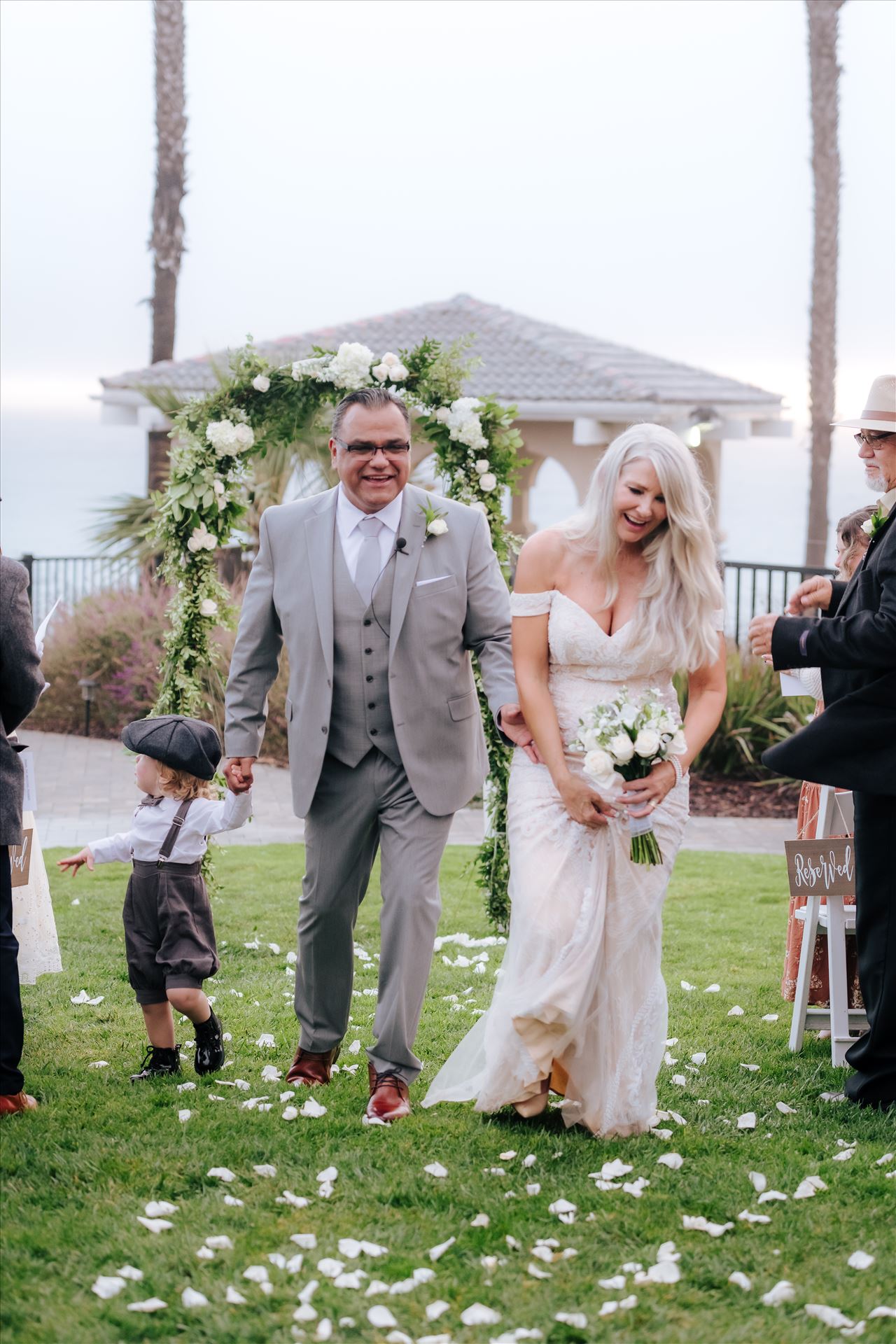 Final-8183.jpg - Rainy day wedding at the Shore Cliff Hotel Gazebo in Pismo Beach, California in San Luis Obispo County by Mirror's Edge Photography.  Winter Wedding vibes at the Shore Cliff Gazebo Bride and Groom on lawn. by Sarah Williams