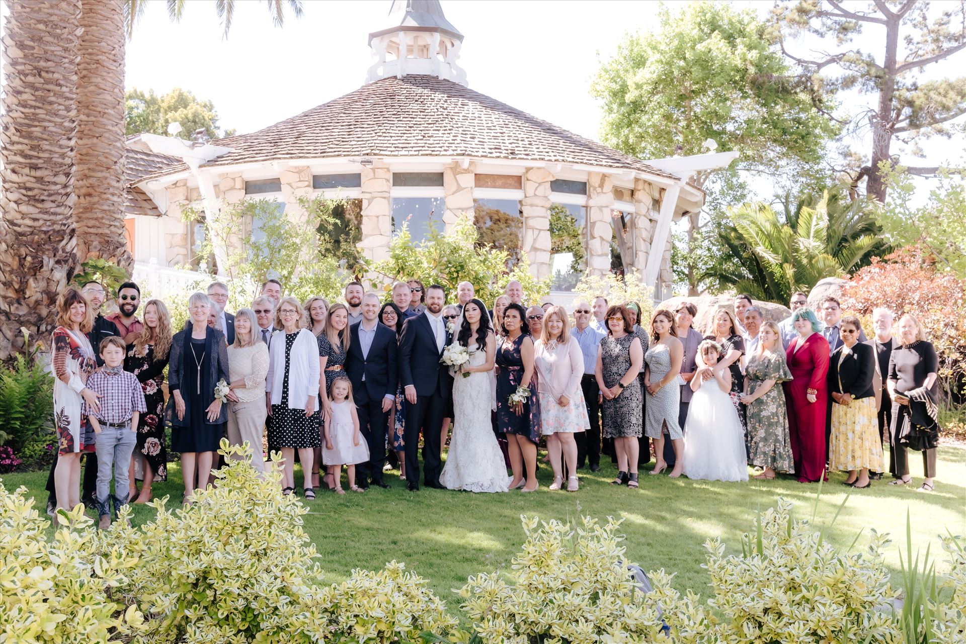 SP Gallery-1325.JPG - Mirror's Edge Photography captures Xochitl and David's magical Madonna Inn Wedding in San Luis Obispo, California. The entire family in front of the Round Room, group photo Bride and Groom and family. by Sarah Williams