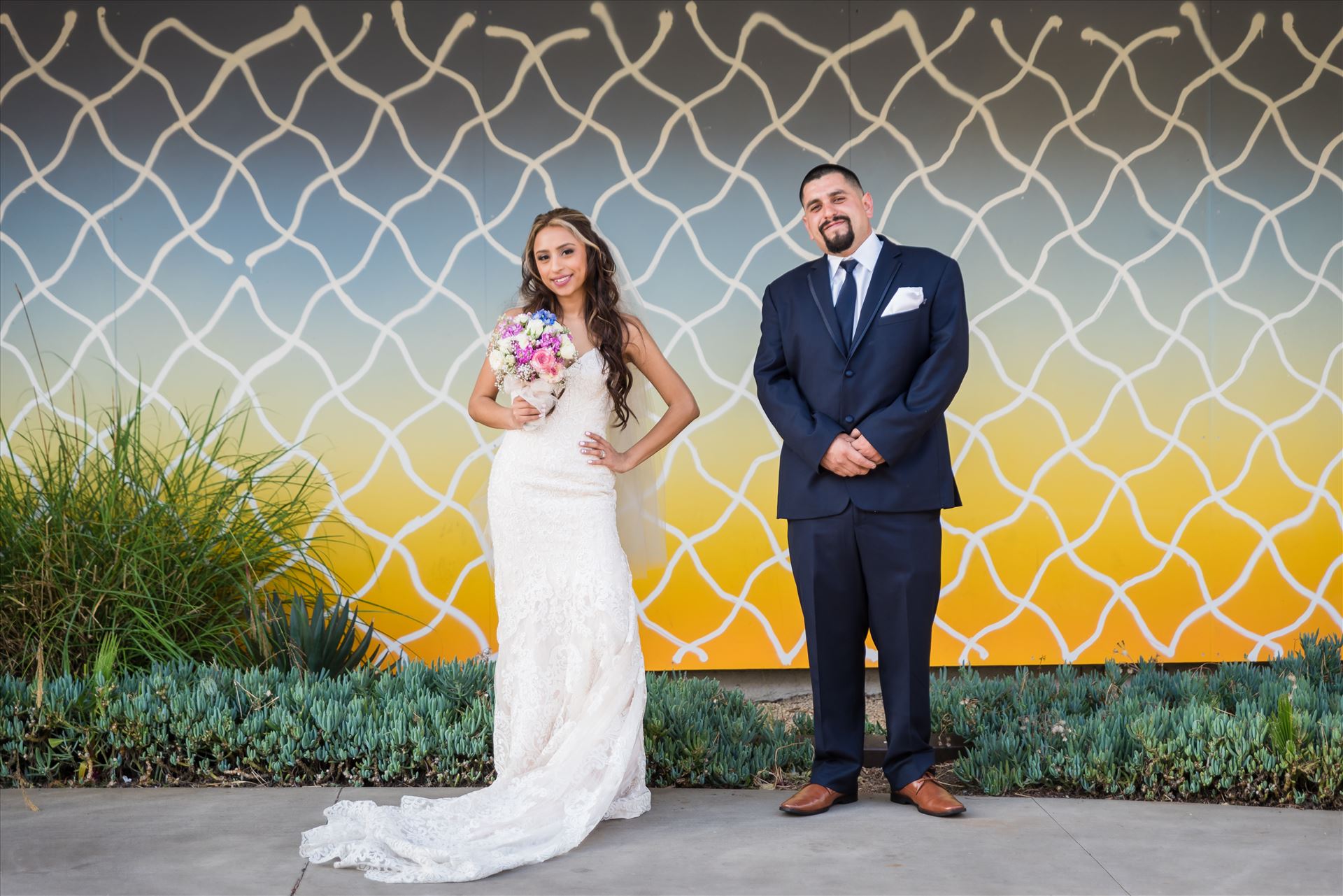 Ana and Juan 65 - Wedding photography at the Kimpton Goodland Hotel in Santa Barbara California by Mirror's Edge Photography.  Bride and Groom by Retro Art Wall by Sarah Williams