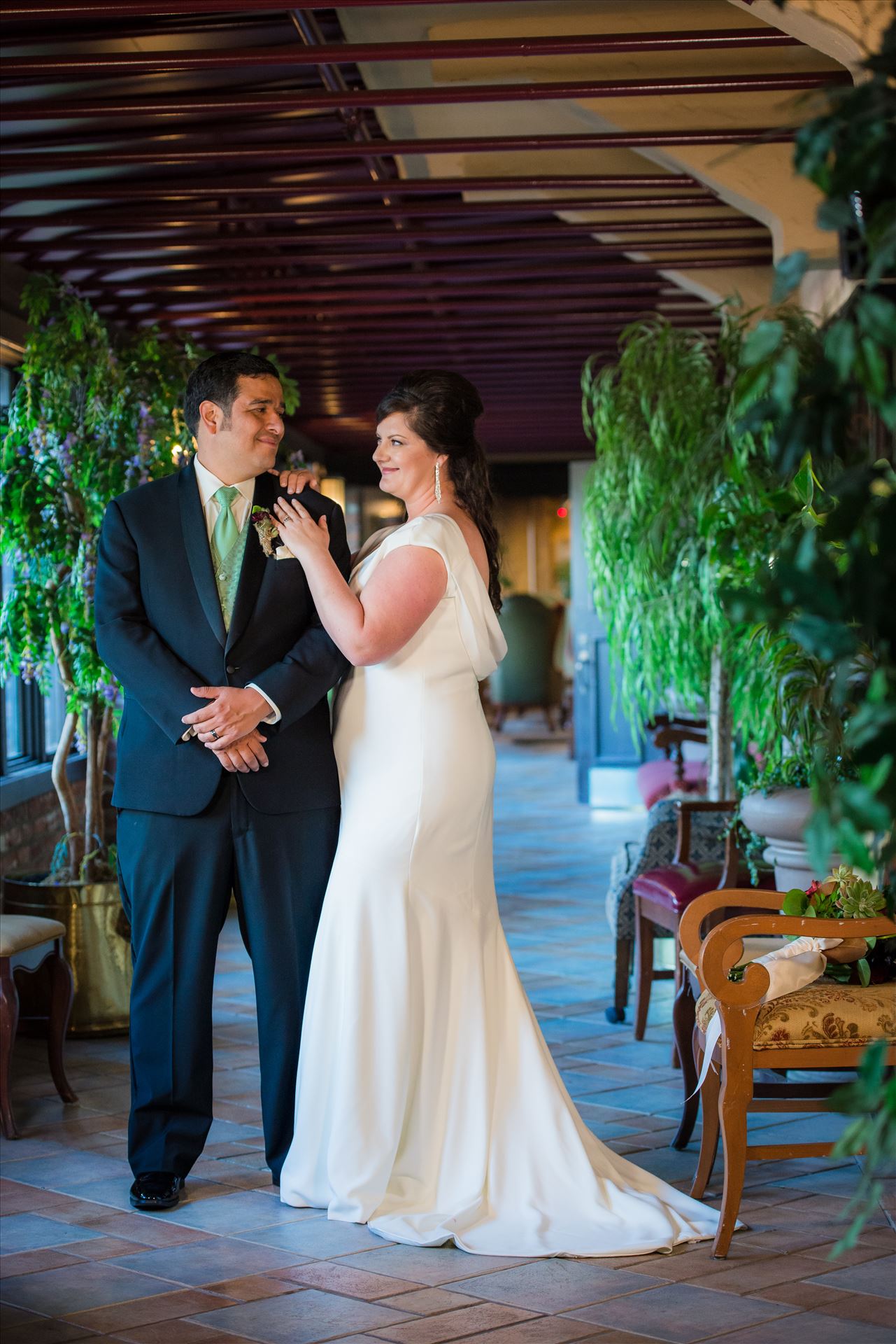 Mary and Alejandro 14 - Wedding photography at the Historic Santa Maria Inn in Santa Maria, California by Mirror's Edge Photography. Bride and Groom in breezeway between the Taproom and the Front Desk at the Santa Maria Inn after wedding. by Sarah Williams