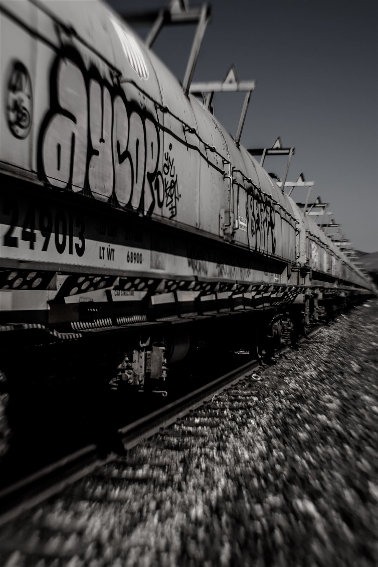 Graffiti Tankers Desaturated.jpg - Graffiti on oil tankers and infinity train tracks by Sarah Williams