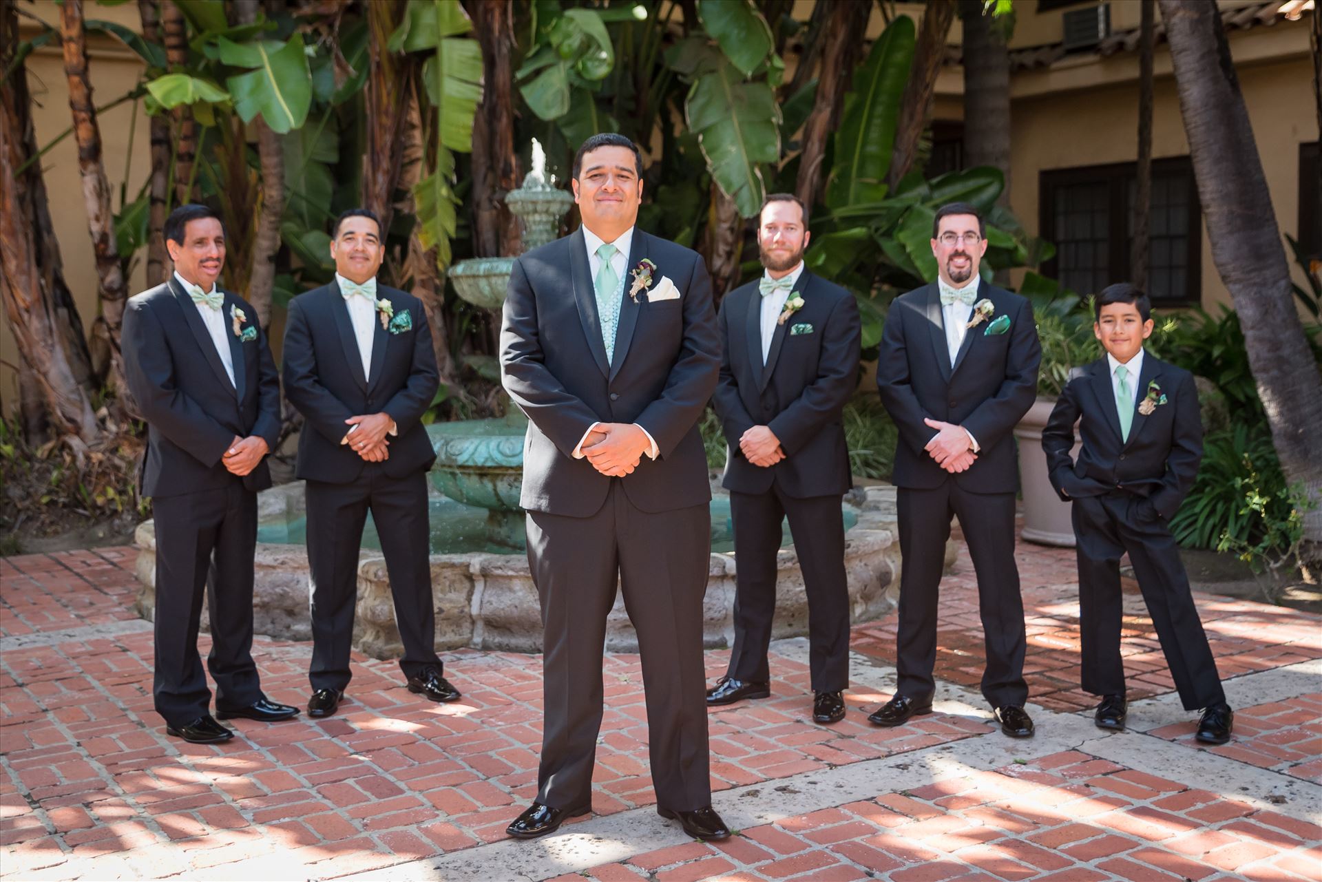 Mary and Alejandro 46 - Wedding photography at the Historic Santa Maria Inn in Santa Maria, California by Mirror's Edge Photography. Groom and his groomsmen by the fountain by Sarah Williams