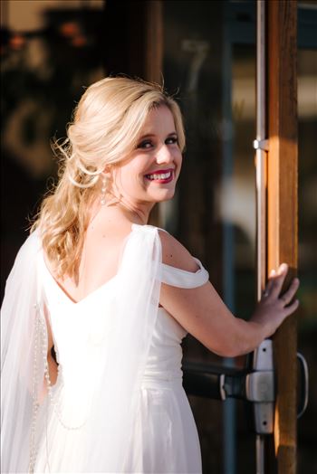 Sarah Williams of Mirror's Edge Photography, a San Luis Obispo Wedding and Engagement Photographer, captures Ryan and Joanna's wedding at the iconic Windows on the Water Restaurant in Morro Bay, California.  Bride enters before ceremony.