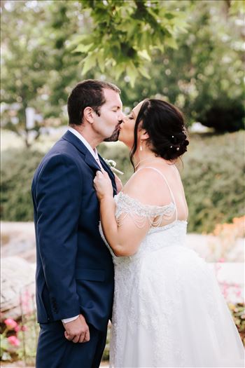 Mirror's Edge Wedding Photography, a San Luis Obispo and Santa Barbara County photographer capture the Nagy's Madonna Inn Wedding. Kiss by Secret Garden Fountain.