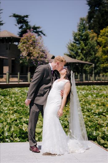 Mirror's Edge Photography captures a high tea wedding at the Cypress Ridge Golf Club and Pavilion in Arroyo Grande, California.  Bride and Groom kiss by the lake