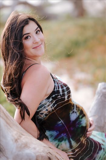 Sarah Williams of Mirror's Edge Photography, a San Luis Obispo County Wedding, Luxury Boudoir and Maternity Photographer captures Ali Marie and Cody's Maternity Session in Pismo Beach. Beautiful mother to be leaning against fallen tree with baby bump