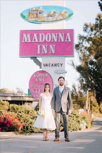 Mirror's Edge Photography captures Sarah and David's magical Madonna Inn Wedding in San Luis Obispo, California. Bride and Groom vintage vibe in front of Madonna Inn Sign.