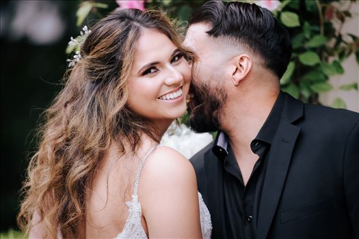 Kaleidoscope Inn and Gardens wedding in Nipomo in San Luis Obispo County by Mirror's Edge Photography.  Gorgeous rose gardens and Victorian home vibe with romance and deep colors.  Bride and Groom kiss by the roses