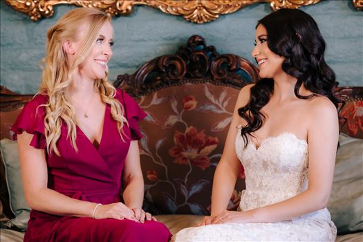 Mirror's Edge Photography captures Xochitl and David's magical Madonna Inn Wedding in San Luis Obispo, California. Bride and Bridesmaid in the Romance Suite.