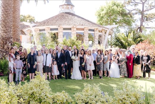 Mirror's Edge Photography captures Xochitl and David's magical Madonna Inn Wedding in San Luis Obispo, California. The entire family in front of the Round Room, group photo Bride and Groom and family.