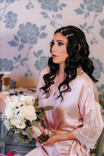 Mirror's Edge Photography captures Xochitl and David's magical Madonna Inn Wedding in San Luis Obispo, California. Bride getting ready in the Romance Suite.