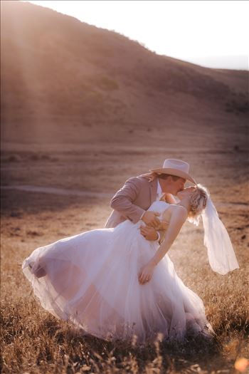 Sarah Williams of Mirror's Edge Photography, a San Luis Obispo and Santa Barbara County Wedding and Engagement Photographer, captures Katie and Joe's country chic wedding in Lompoc, California.  Sunset glow dip and kiss on the family ranch.
