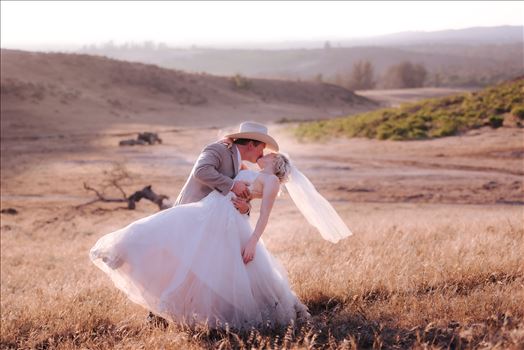 Sarah Williams of Mirror's Edge Photography, a San Luis Obispo and Santa Barbara County Wedding and Engagement Photographer, captures Katie and Joe's country chic wedding in Lompoc, California.  Dip and kiss at sunset on the ranch.