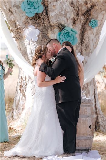 Mirror's Edge Photography, a San Luis Obispo Wedding Photographer, captures a wedding at the Historic Dana Adobe in Nipomo California.  Ceremony under the tree with the kiss.