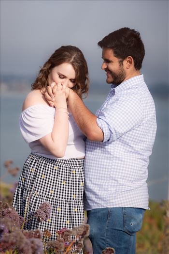 Sarah Williams of Mirror's Edge Photography, a San Luis Obispo Wedding and Engagement Photographer, captures Kara-Leigh and Deaven's amazing Engagement Photography Session at the Dinosaur Caves Park in Pismo Beach California. Girl kisses hand.